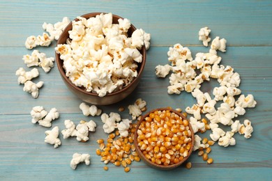 Photo of Tasty popcorn and corn kernels on blue wooden table, flat lay