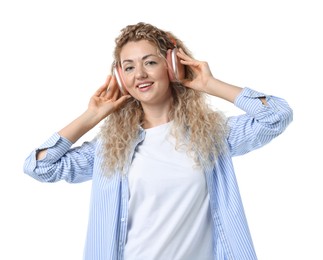 Photo of Happy woman listening to music in headphones and dancing on white background