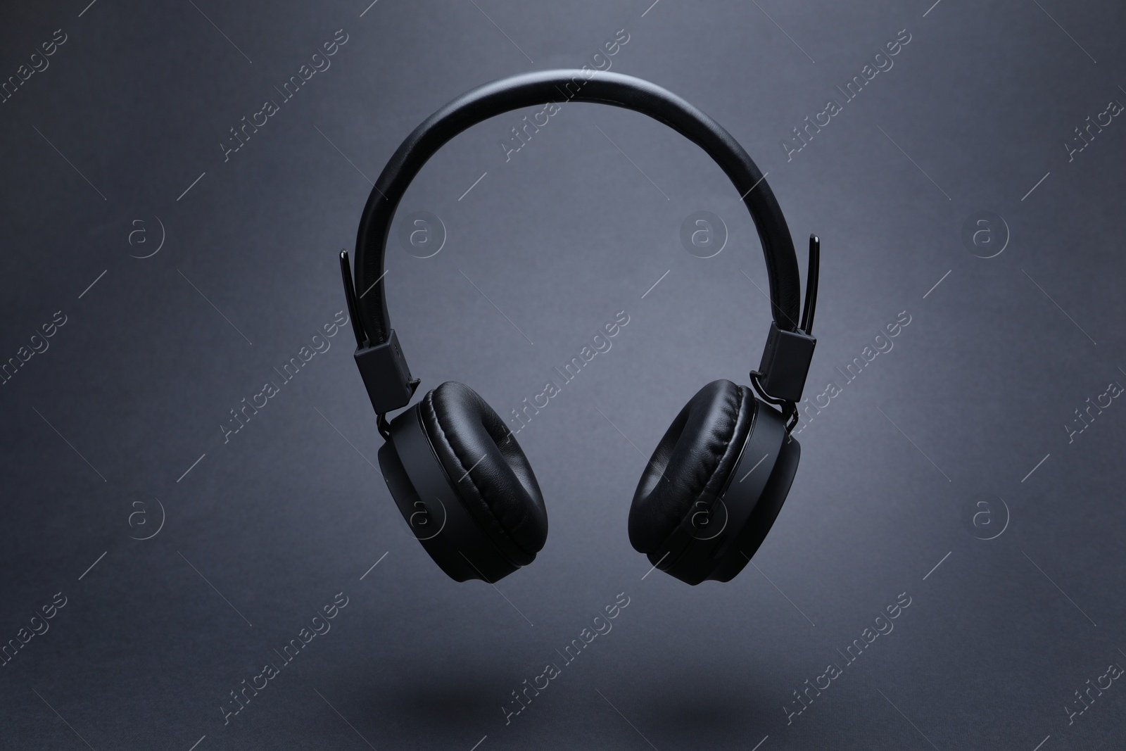 Pair of wireless headphones on grey background Photo of Pair of wireless headphones on grey background