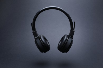 Photo of Pair of wireless headphones on grey background