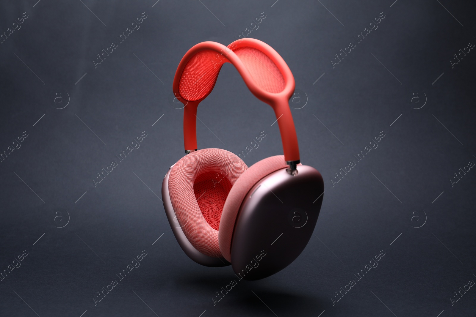 Pair of wireless headphones on grey background Photo of Pair of wireless headphones on grey background