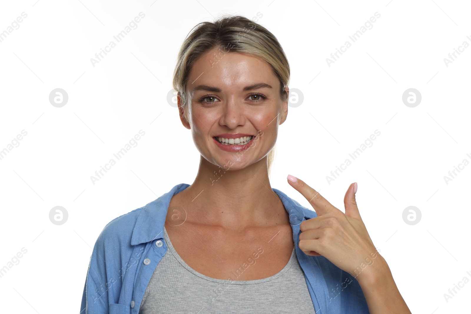 Photo of Woman pointing at her healthy teeth on white background
