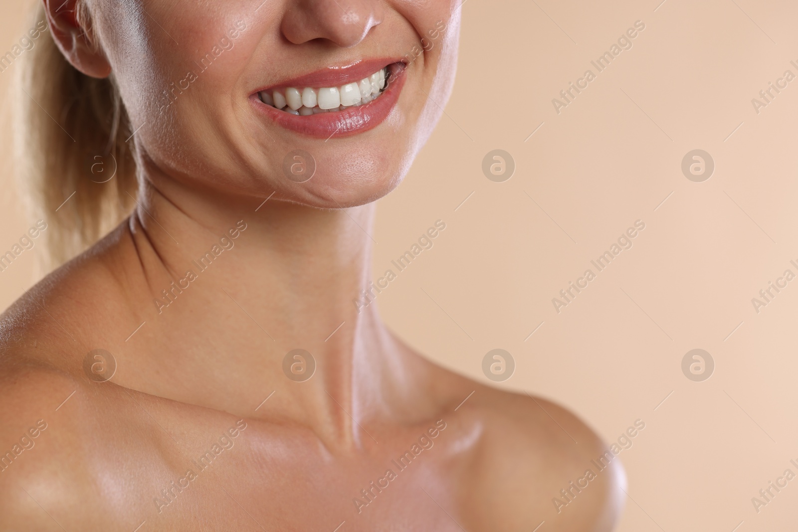 Photo of Woman with beautiful healthy teeth on beige background, closeup. Space for text
