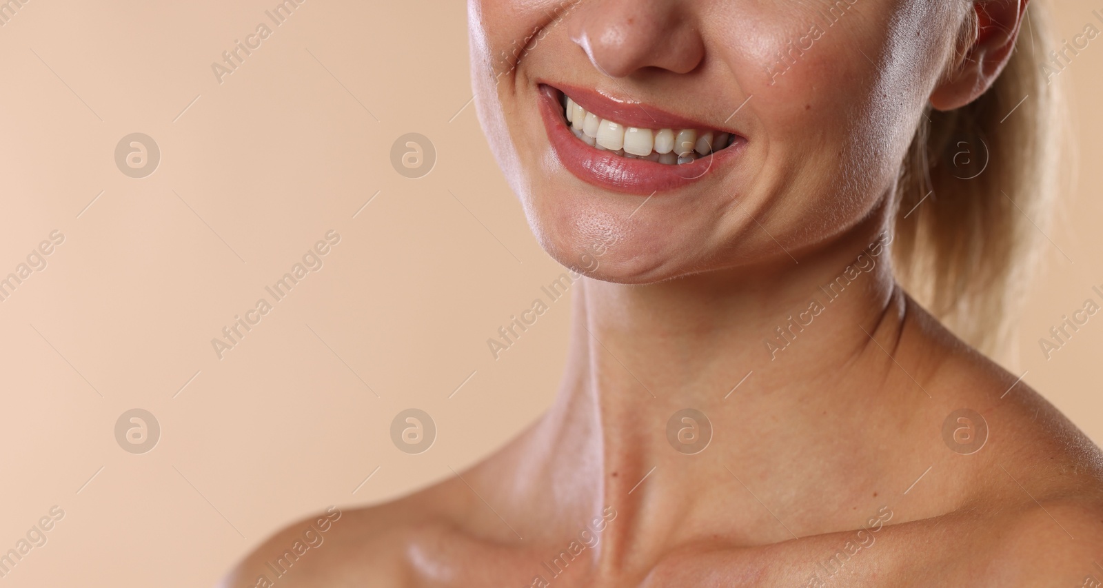 Photo of Woman with beautiful healthy teeth on beige background, closeup. Space for text