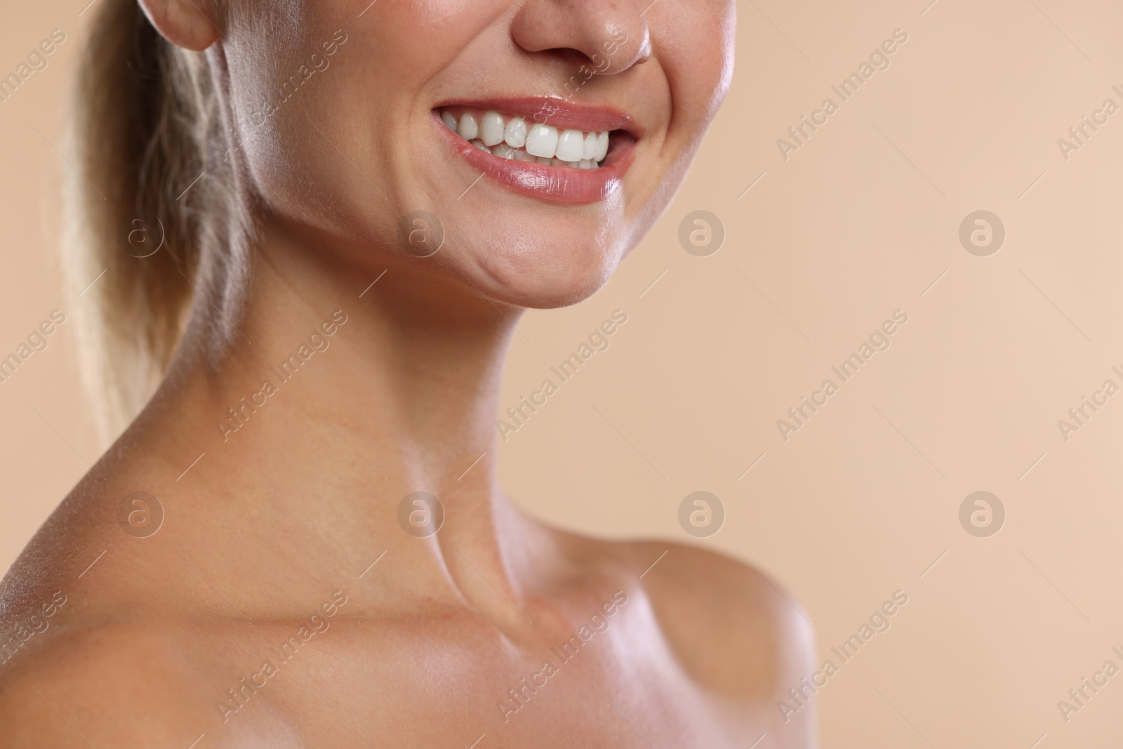 Photo of Woman with beautiful healthy teeth on beige background, closeup. Space for text