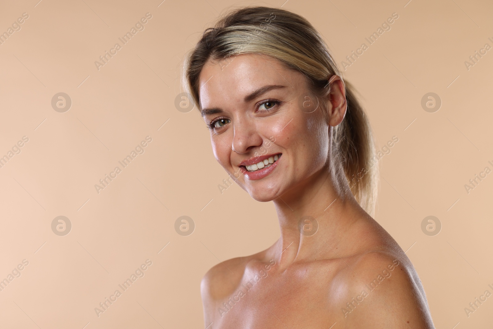 Photo of Woman with beautiful healthy teeth on beige background. Space for text
