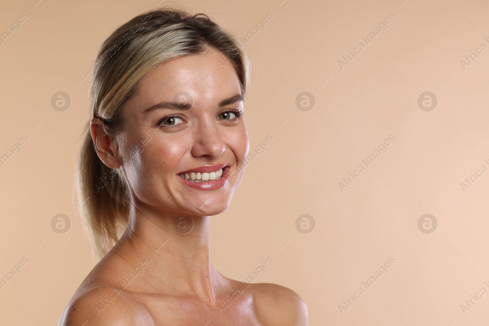 Photo of Woman with beautiful healthy teeth on beige background. Space for text