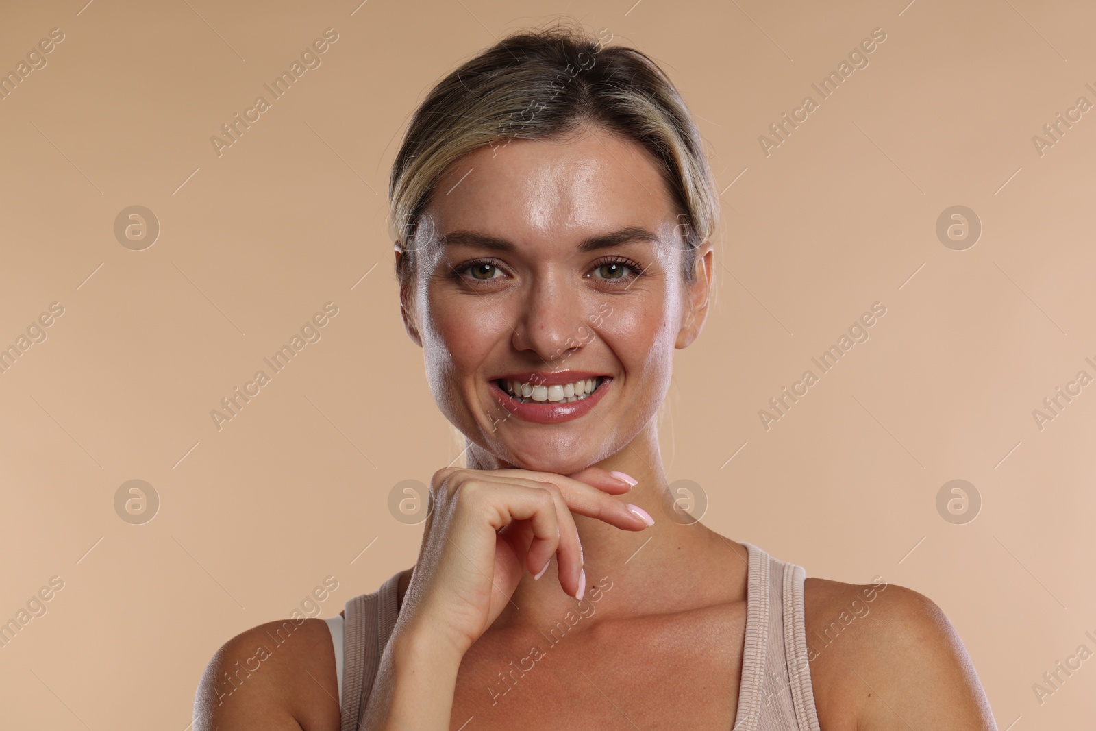 Woman with beautiful healthy teeth on beige background Photo of Woman with beautiful healthy teeth on beige background