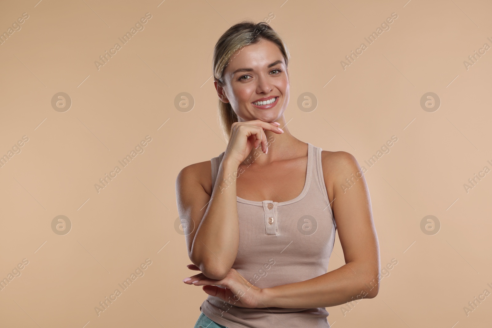 Photo of Woman with beautiful healthy teeth on beige background