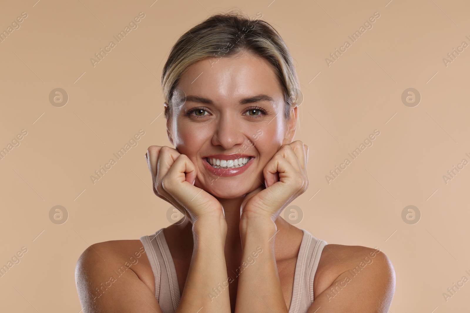 Photo of Woman with beautiful healthy teeth on beige background