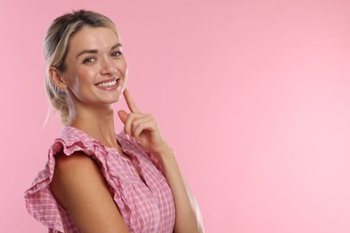 Photo of Woman with beautiful healthy teeth on pink background. Space for text