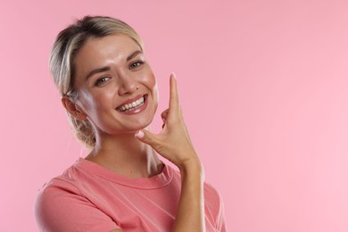 Photo of Woman with beautiful healthy teeth on pink background. Space for text