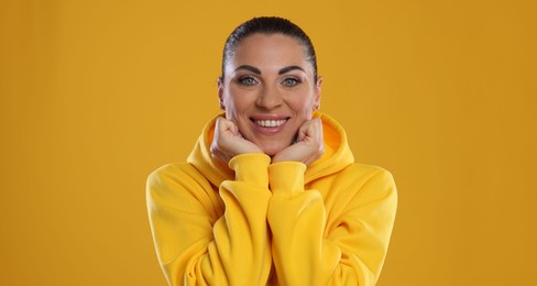 Photo of Woman with beautiful healthy teeth on yellow background