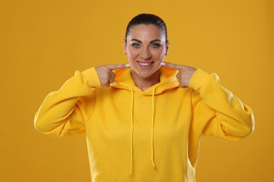 Photo of Woman with beautiful healthy teeth on yellow background
