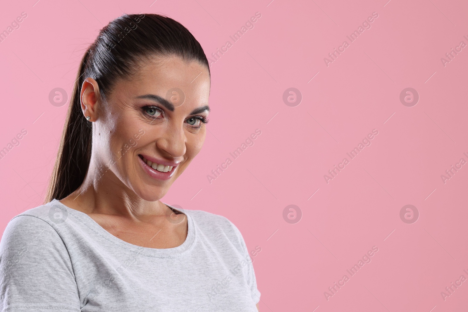 Photo of Woman with beautiful healthy teeth on pink background. Space for text