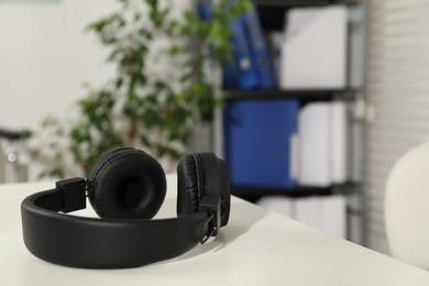 Photo of Wireless headphones on white background indoors, closeup. Space for text