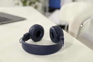 Photo of Wireless headphones on white background indoors, closeup