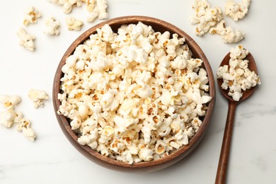 Photo of Tasty popcorn on white table, flat lay