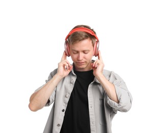 Photo of Young man listening to music in headphones on white background