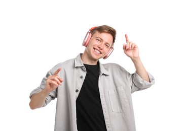 Photo of Happy man listening to music in headphones and dancing on white background