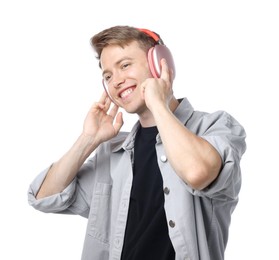 Photo of Happy man listening to music in headphones and dancing on white background