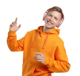 Photo of Happy man listening to music in headphones and dancing on white background
