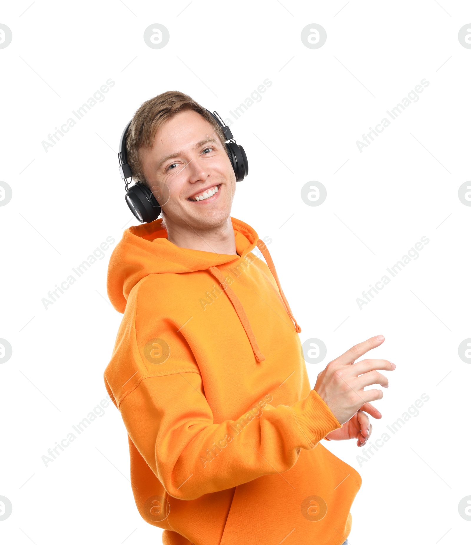 Happy man listening to music in headphones and dancing on white background Photo of Happy man listening to music in headphones and dancing on white background