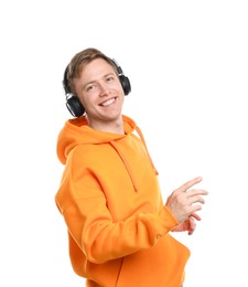 Photo of Happy man listening to music in headphones and dancing on white background