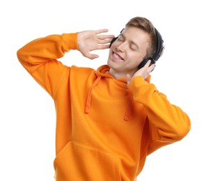 Photo of Happy man listening to music in headphones and dancing on white background