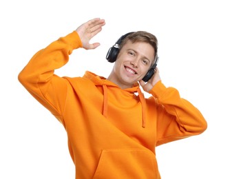 Photo of Happy man listening to music in headphones and dancing on white background