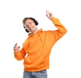Photo of Happy man listening to music in headphones and dancing on white background