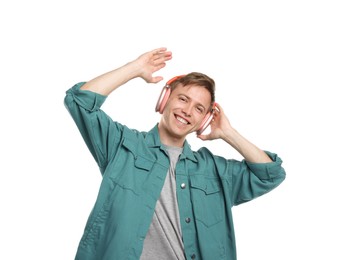 Photo of Happy man listening to music in headphones and dancing on white background