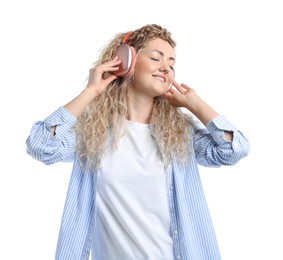 Photo of Happy woman listening to music in headphones and dancing on white background