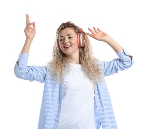 Photo of Happy woman listening to music in headphones and dancing on white background