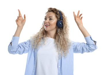Photo of Happy woman listening to music in headphones and dancing on white background