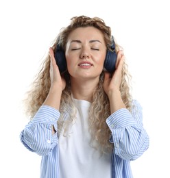 Photo of Happy woman listening to music in headphones and dancing on white background