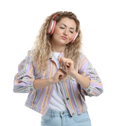 Photo of Beautiful woman listening to music in headphones and dancing on white background