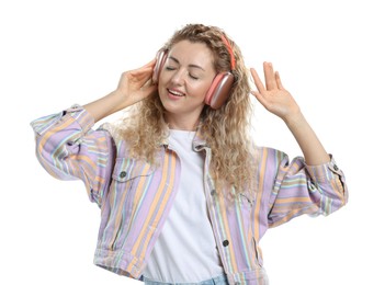 Photo of Happy woman listening to music in headphones and dancing on white background