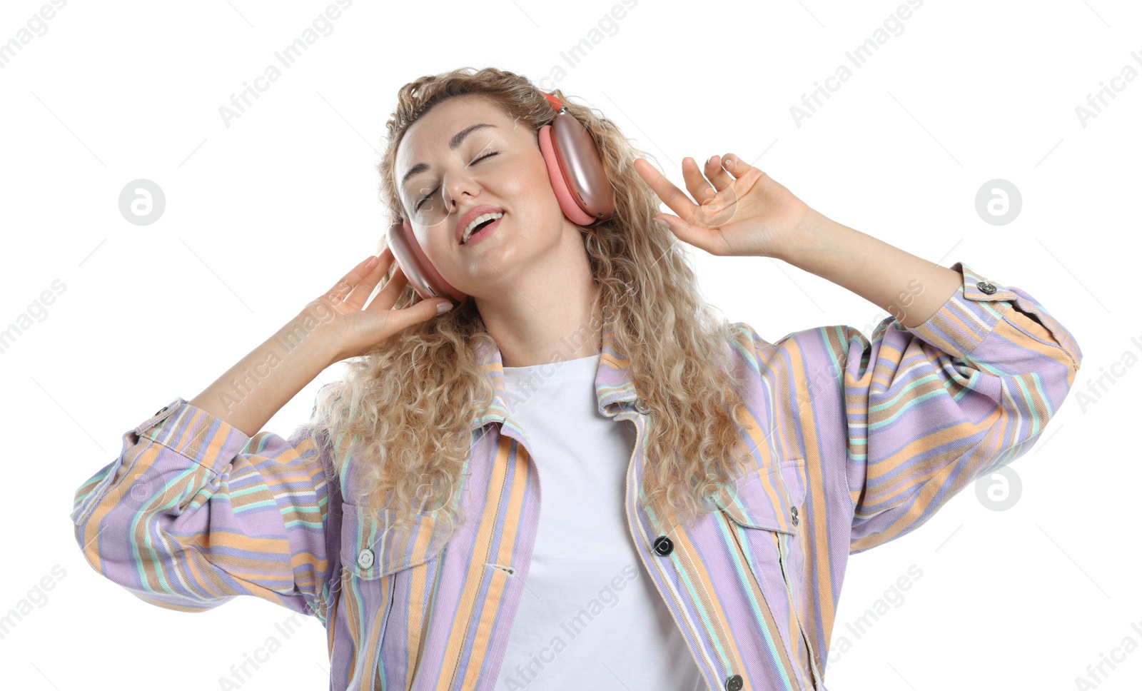 Happy woman listening to music in headphones and dancing on white background Photo of Happy woman listening to music in headphones and dancing on white background