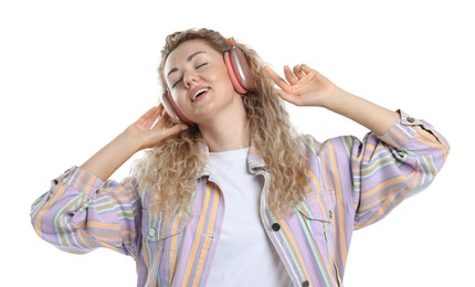 Photo of Happy woman listening to music in headphones and dancing on white background