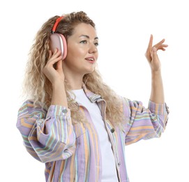 Photo of Happy woman listening to music in headphones and dancing on white background