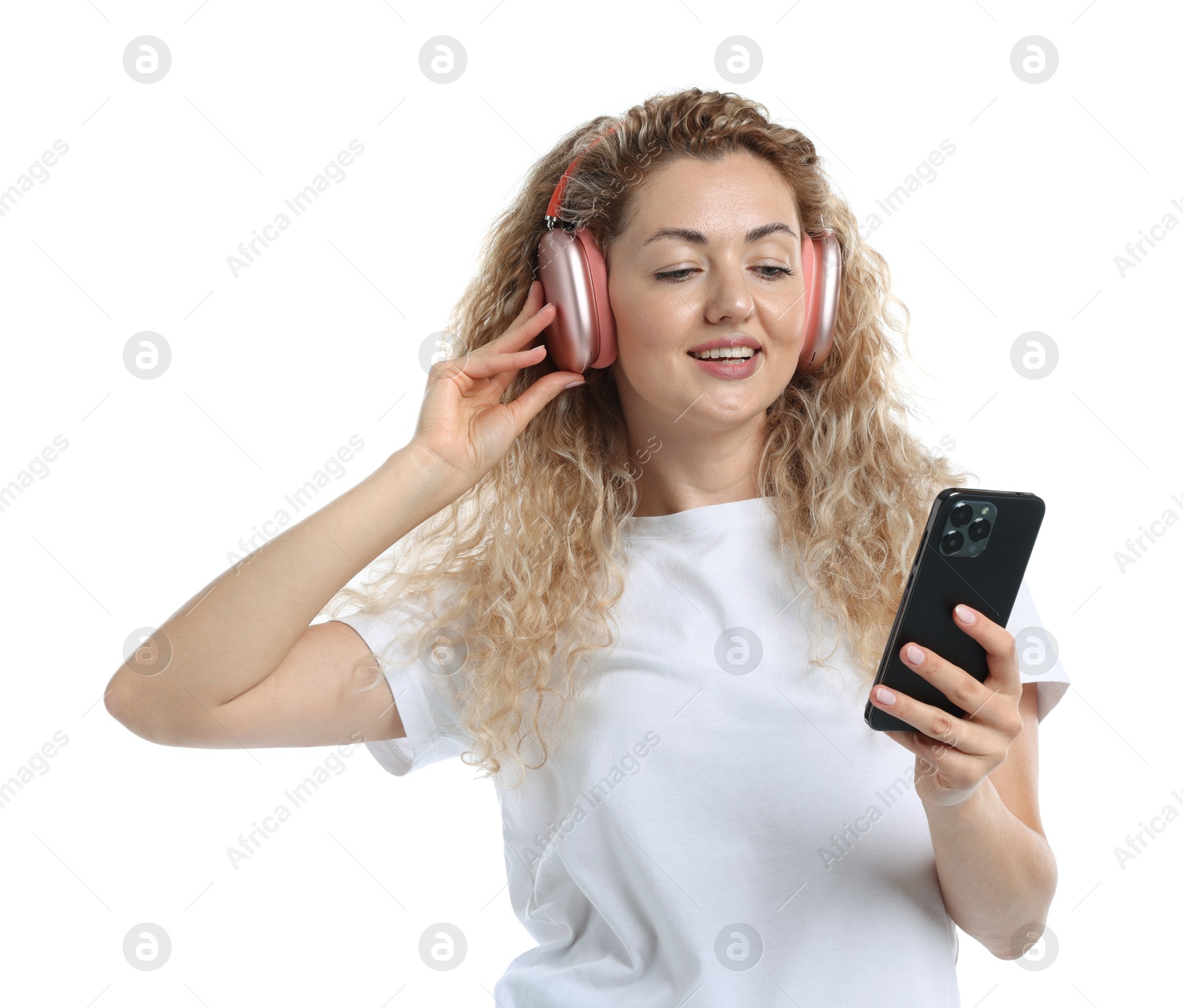 Photo of Happy woman with smartphone listening to music in headphones on white background