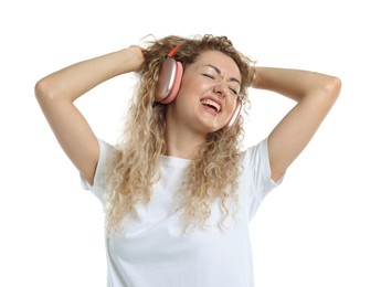 Photo of Happy woman listening to music in headphones and dancing on white background