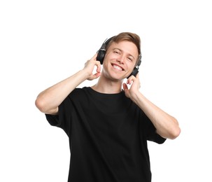 Photo of Happy man listening to music in headphones and dancing on white background