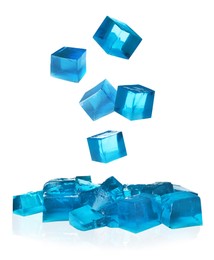 Image of Yummy blue jelly cubes falling on white background