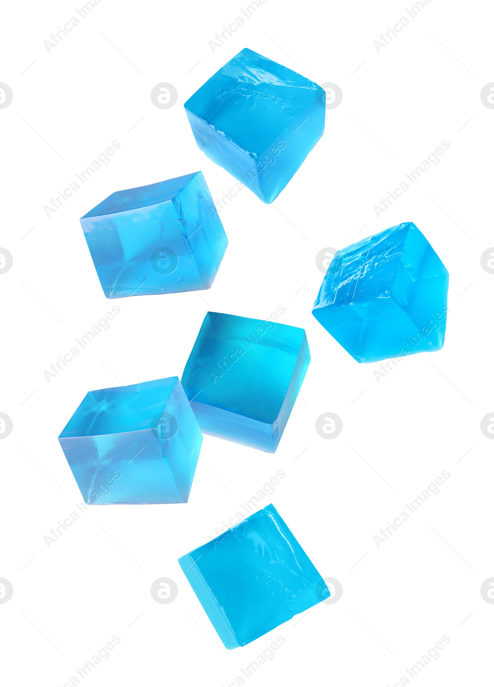 Image of Yummy blue jelly cubes falling on white background