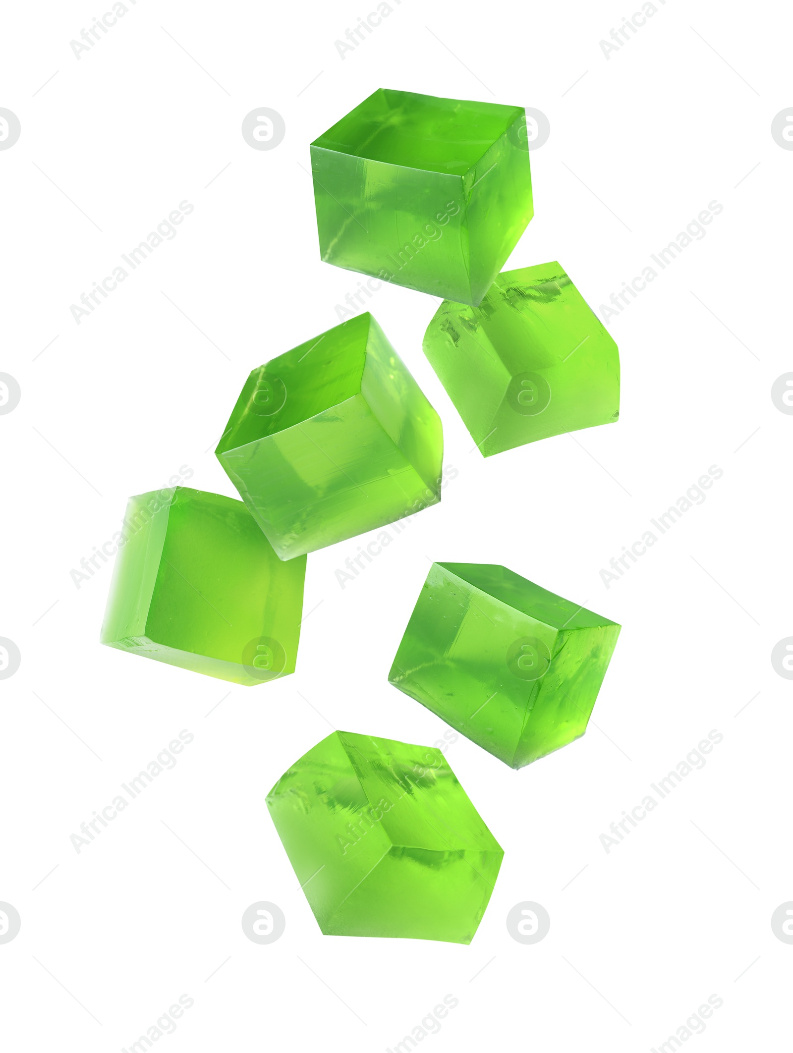 Image of Yummy green jelly cubes falling on white background