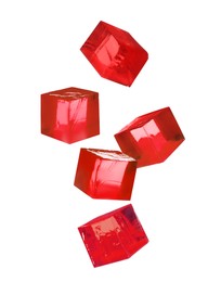 Image of Yummy red jelly cubes falling on white background