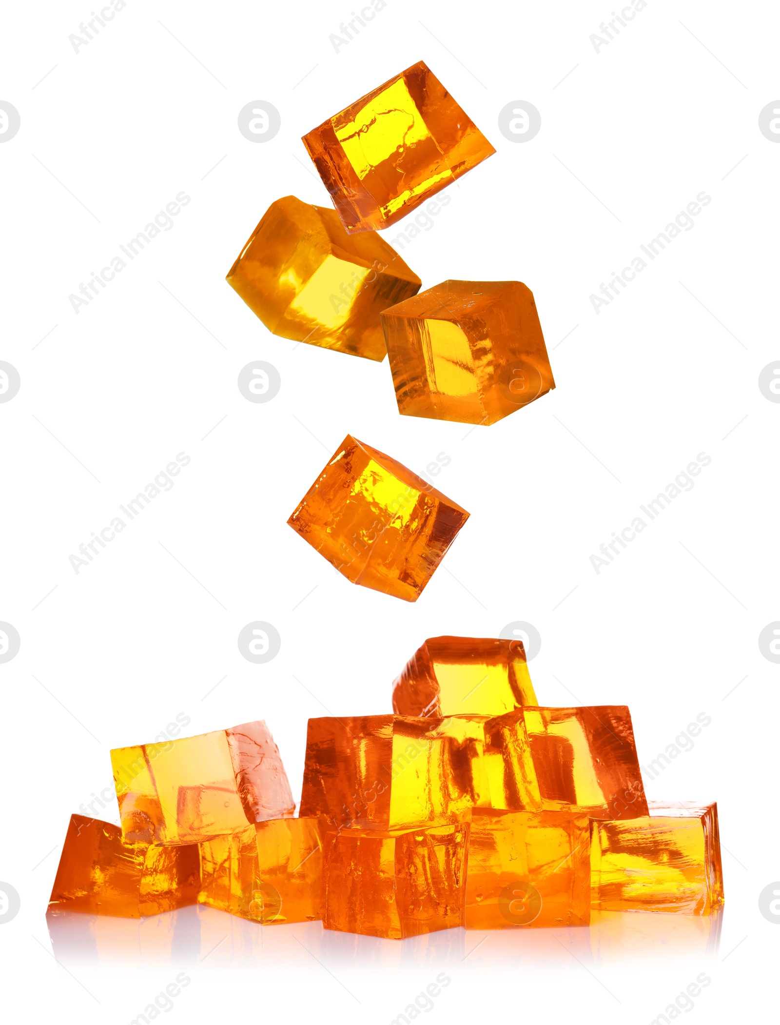 Yummy orange jelly cubes falling on white background Image of Yummy orange jelly cubes falling on white background