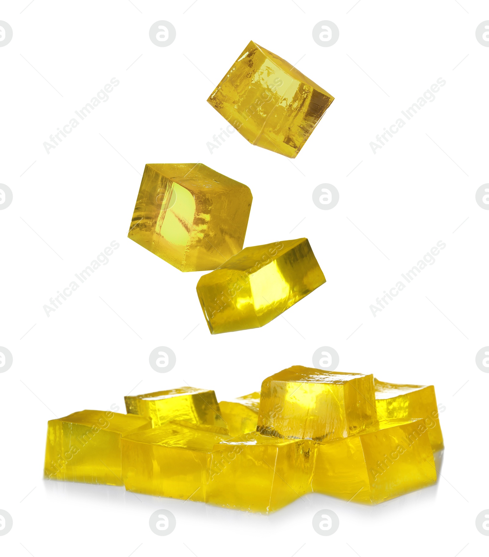 Yummy yellow jelly cubes falling on white background Image of Yummy yellow jelly cubes falling on white background